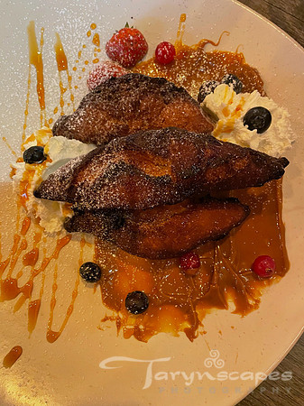3 crispy pastry drizzeled with caramel, blueberries, raspberries and whipped cream