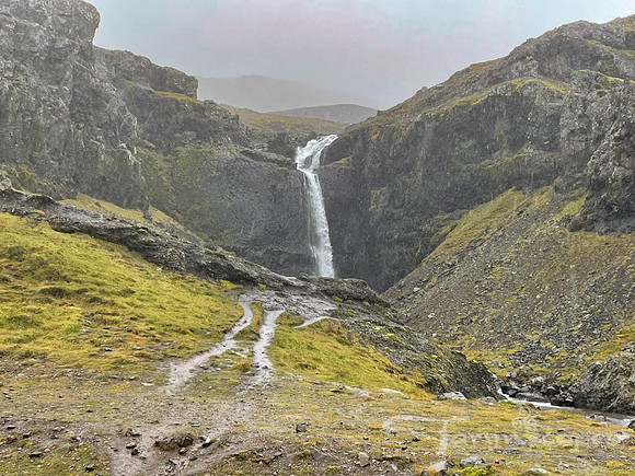 Misty waterfall pushed back into the mountain