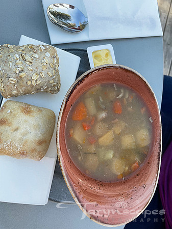 Brothy stew with carrots potatoes and bread