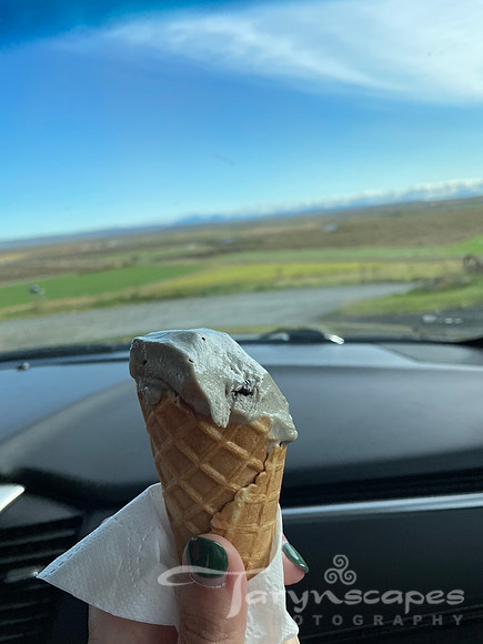half eaten ice cream cone with a view of the road ahead.