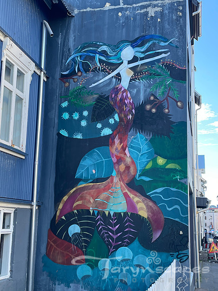 Mermaid mural on the side of a building