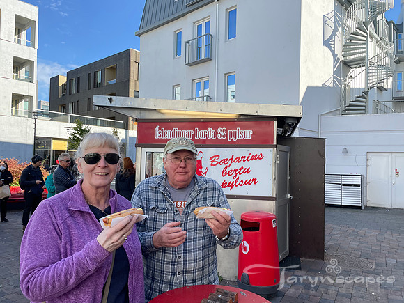 Mom and dad each holding an Icelandic hotdog.