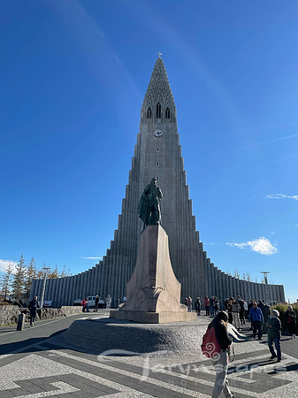 a tall church its long, central tower and sloping sides resemble a gigantic stalagmite of petrified lava residue.
