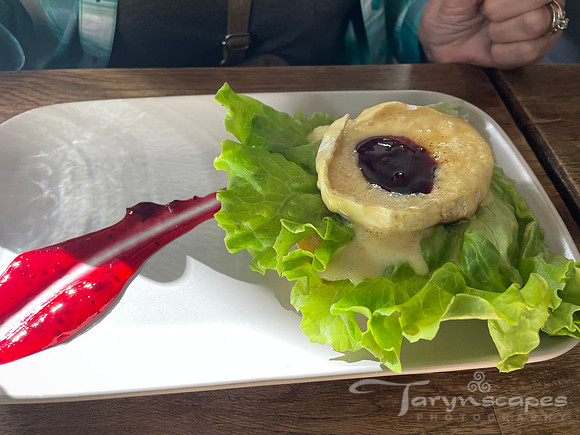 Melty brie ontop a bed of lettuce with a dollup of jam