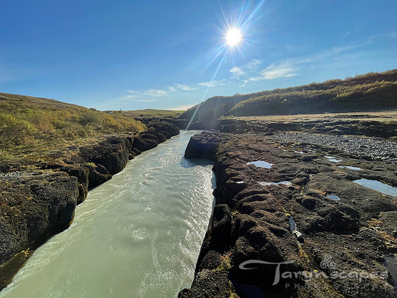 Milky stream cuts through the vast rocky landscape