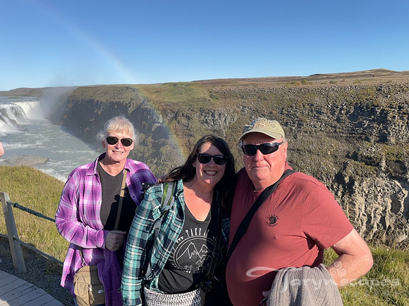 My mom, me and dad near gullfoss with a rainbow above us.