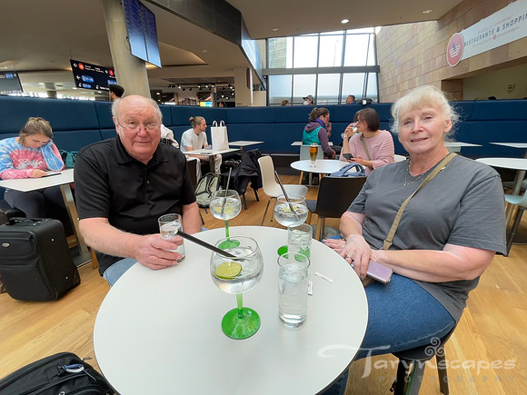 My parents sitting at a table with 3 gin and tonics