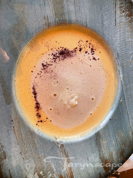 a bowl of creamy orange langoustine soup