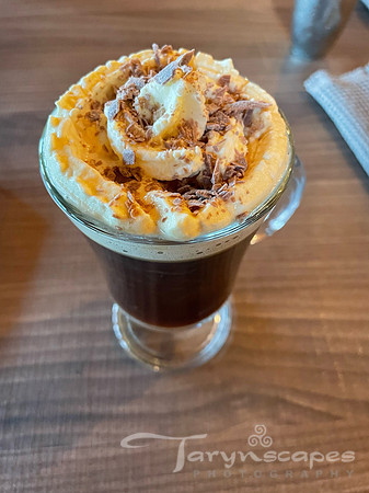 shot glass with a dessert topped with whipped cream and chocolate crumbles