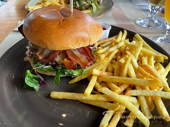 A bacon cheesebuger with long skinny fries