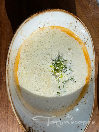 langustine soup topped with cream and herbs